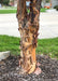 Closeup of low branched trunk showing shedding peeling bark curling away from the trunk.